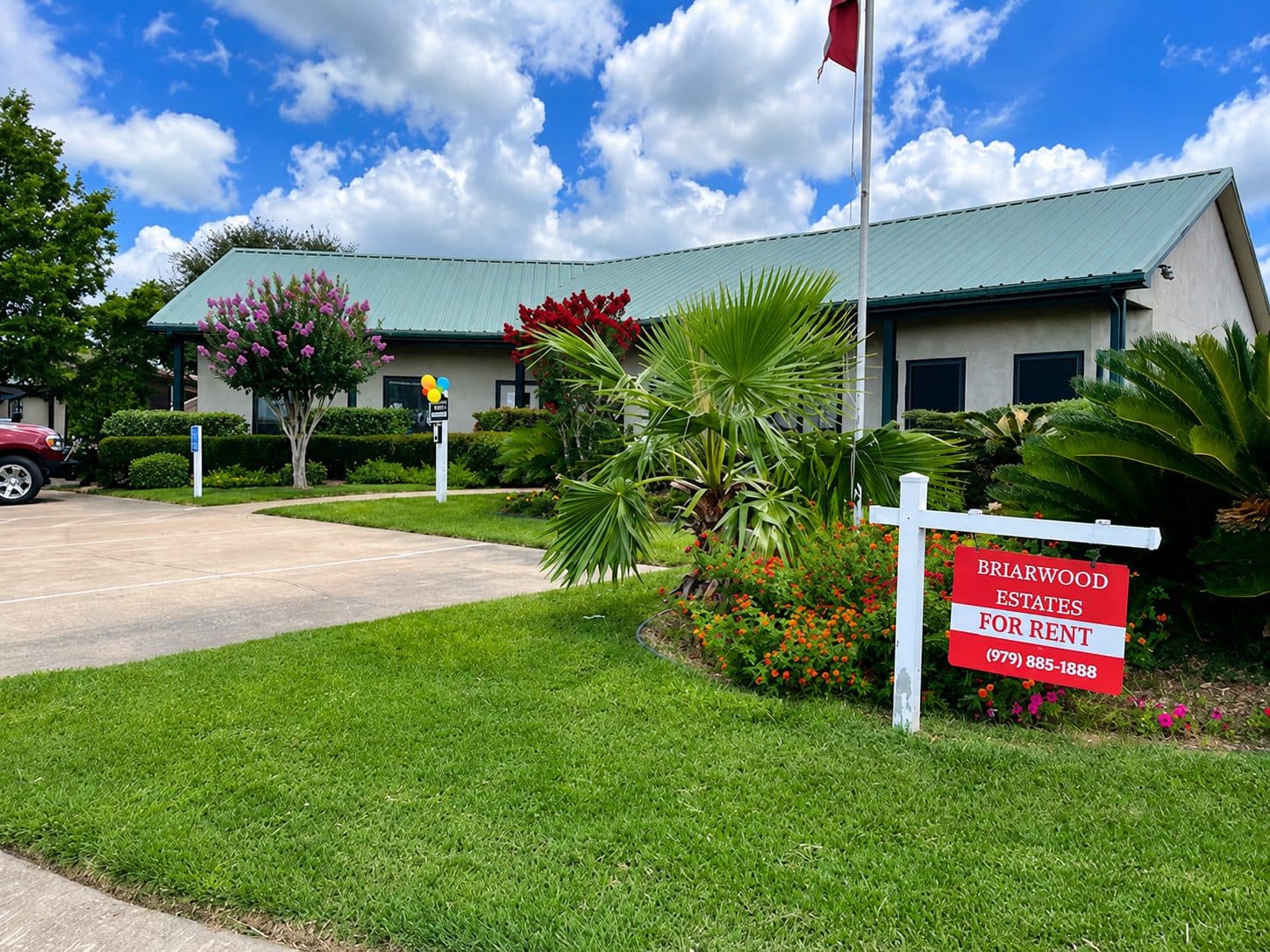 Briarwood Estates clubhouse with landscaping and a community sign in the foreground