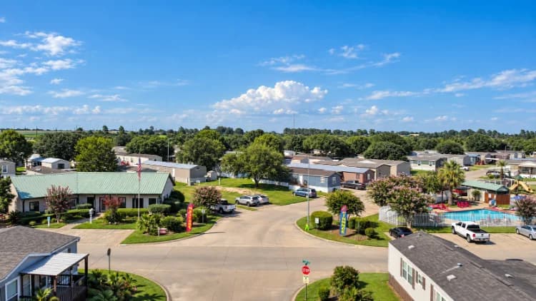 Aerial view of the Briarwood Estates entrance drive with the pool and clubhouse area
